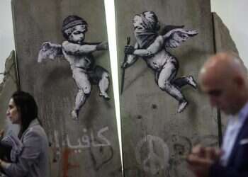 Banksy creates replica separation wall for London travel fair