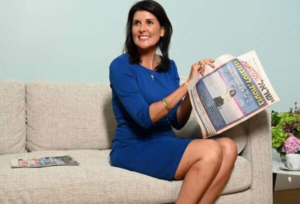 Former US Ambassador to the UN Nikki Haley holds a copy of Israel Hayom.