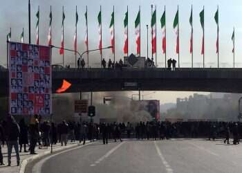 Protests grip major Iranian cities over gas prices; at least 1 killed