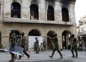 Iraq protesters burn shrine entrance in holy city, say PM quitting 'not enough'