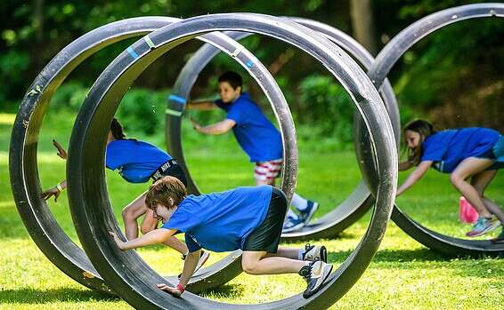 Children participate in an obstacle course with fellow campers Thursday, June 11, 2020, at Camp Guyasuta