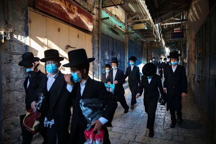 A group of ultra-Orthodox Jewish youth wear protective face masks