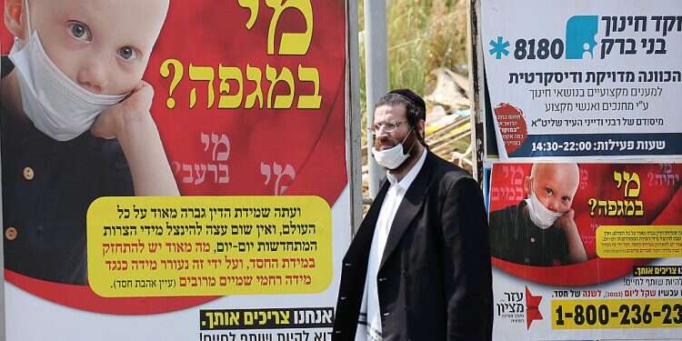 Health Ministry struggles with obstinate Haredi enclaves as leading rabbi tests positive