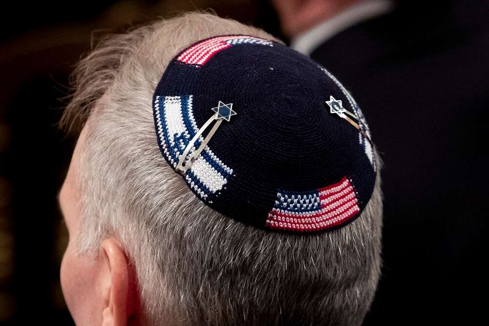 A man wears a kippah depicting the flags of Israel and the US