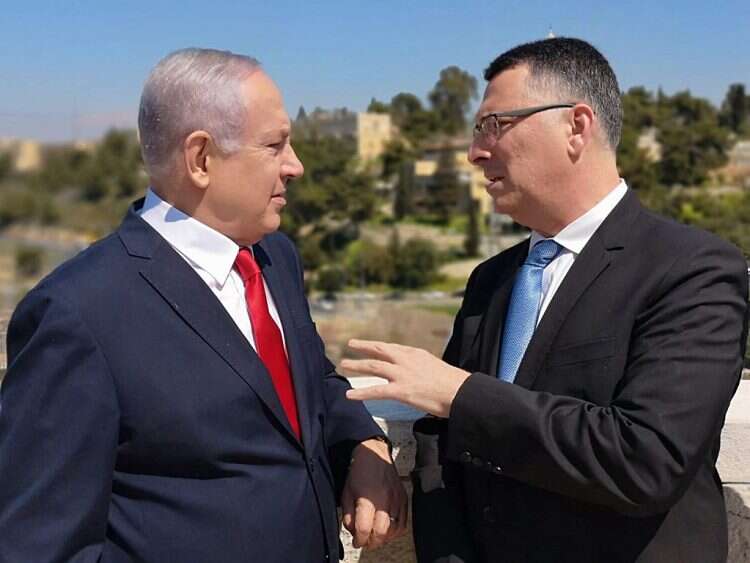 Prime Minister Benjamin Netanyahu speaks with Gideon Sa'ar in 2019