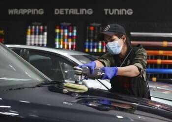 Iranian woman breaks taboos as she details cars at Tehran garage