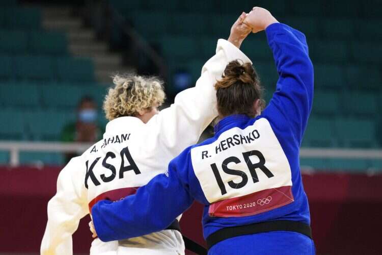 Tahani Al-Qahtani of Saudi Arabia, left, and Raz Hershko of Israel react after competing in their women's +78kg elimination round judo match at the 2020 Summer Olympics, July 30, 2021