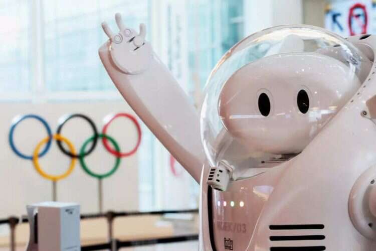 A robot is seen at an information desk in front of the Olympic rings before the arrival of International Olympic Committee in Tokyo, July 8, 2021