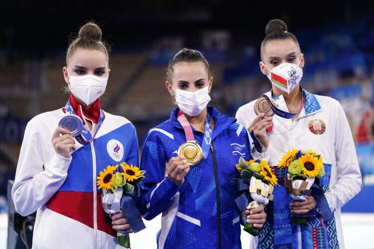 Silver medalist Dina Averina, left, of the Russian Olympic Committee, Israeli gold medalist Linoy Ashram, and bronze medalist Alina Harnasko of Belarus, at the 2020 Tokyo Olympics, Aug. 7, 2021