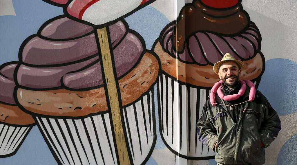 Italian street artist battles racism by turning swastikas into cupcakes