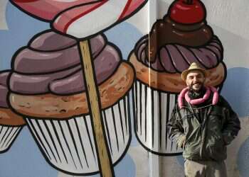 Italian street artist battles racism by turning swastikas into cupcakes