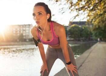 Young sportswoman resting after run