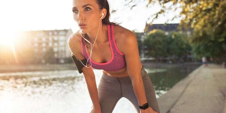Young sportswoman resting after run