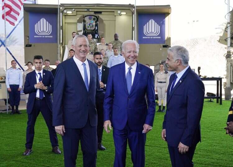 Defense Minister Benny Gantz, left, US President Joe Biden, center, and Prime Minister Yair Lapid, view aerial defense systems, Wednesday, July 13, 2022, in Tel Aviv