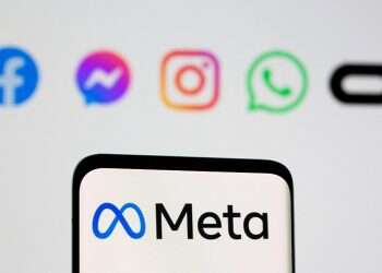 Facebook's new rebrand logo Meta is seen on smartpone in front of displayed logo of Facebook, Messenger, Intagram, Whatsapp, and Oculus in this illustration picture taken October 28, 2021