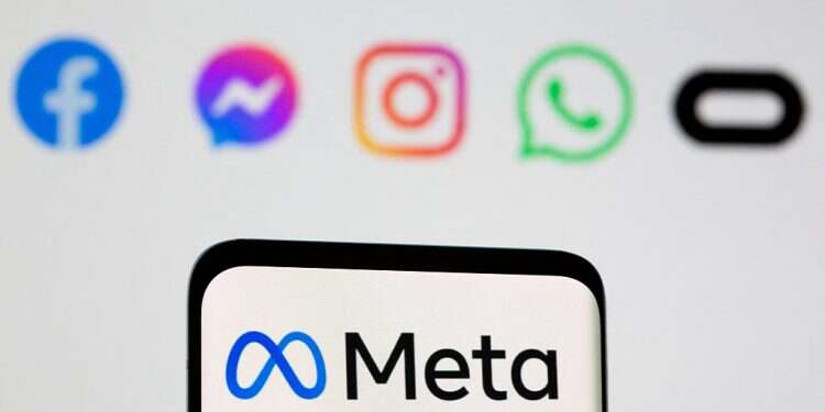 Facebook's new rebrand logo Meta is seen on smartpone in front of displayed logo of Facebook, Messenger, Intagram, Whatsapp, and Oculus in this illustration picture taken October 28, 2021