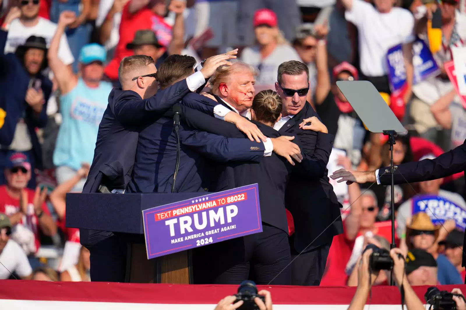 Trump is helped off the stage at a campaign event in Butler, Pennsylvania, July 13 (Gene J. Puskar/AP)