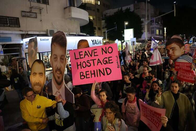 Protesters hold up portraits of Israeli hostages during a march from Dizengoff Square to the US embassy calling to complete the hostage deal between Israel and Hamas, in Tel Aviv, Israel, February 4, 2025