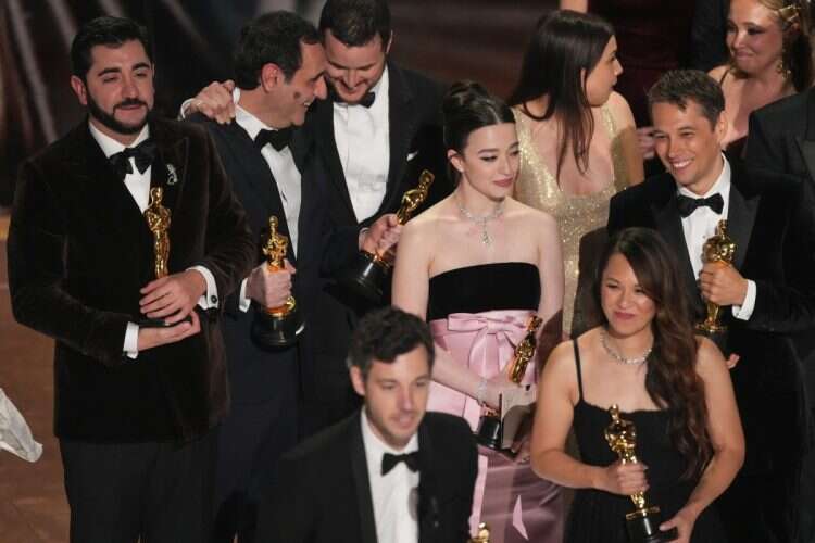 Alex Coco, front left, Samantha Quan, front right, Vache Tovmasyan, Karren Karagulian, Drew Daniel, Mickey Madison, Luna Sofia Miranda, and Sean Baker accept the award for best picture for "Anora" during the Oscars on Sunday, March 2, 2025, at the Dolby Theatre in Los Angeles