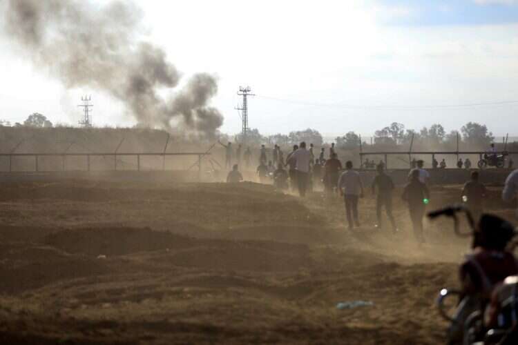 Palestinians break into the Israeli side of Israel-Gaza border fence after Palestinian gunmen infiltrated areas of southern Israel October 7, 2023