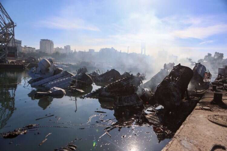 Smoke billows from Syrian naval ships destroyed in an overnight Israeli attack on the port city of Latakia on December 10, 2024