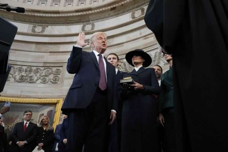 US President Donald Trump takes the oath of office as Melania Trump, Ivanka Trump, Donald Trump Jr. and Eric Trump look on during inauguration ceremonies in the Rotunda of the US Capitol on January 20, 2025 in Washington, DC